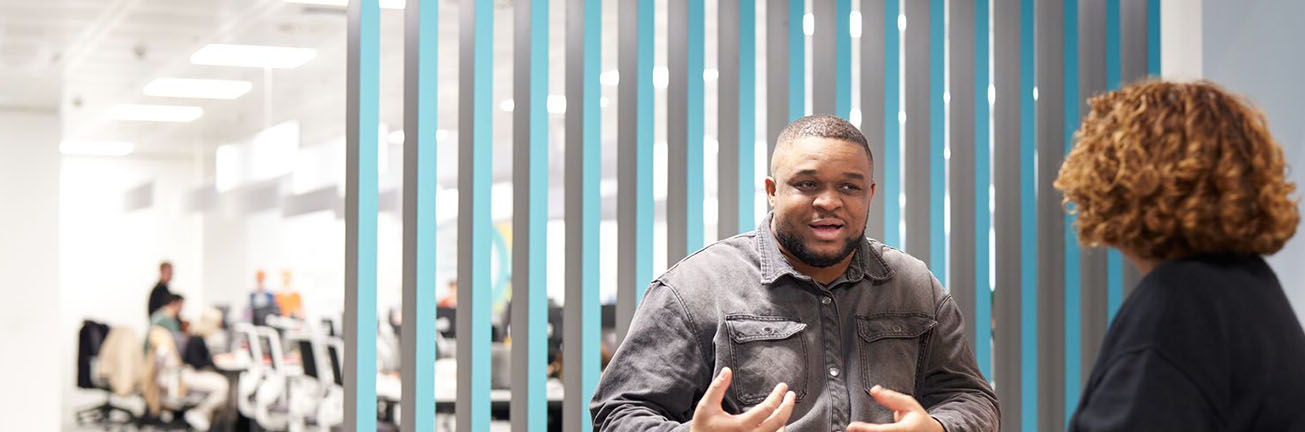 A man and a woman discuss cybersecurity in a modern office, highlighting digital safety, risk management, and secure business operations. A man and a woman discuss cybersecurity in a modern office, highlighting digital safety, risk management, and secure business operations.