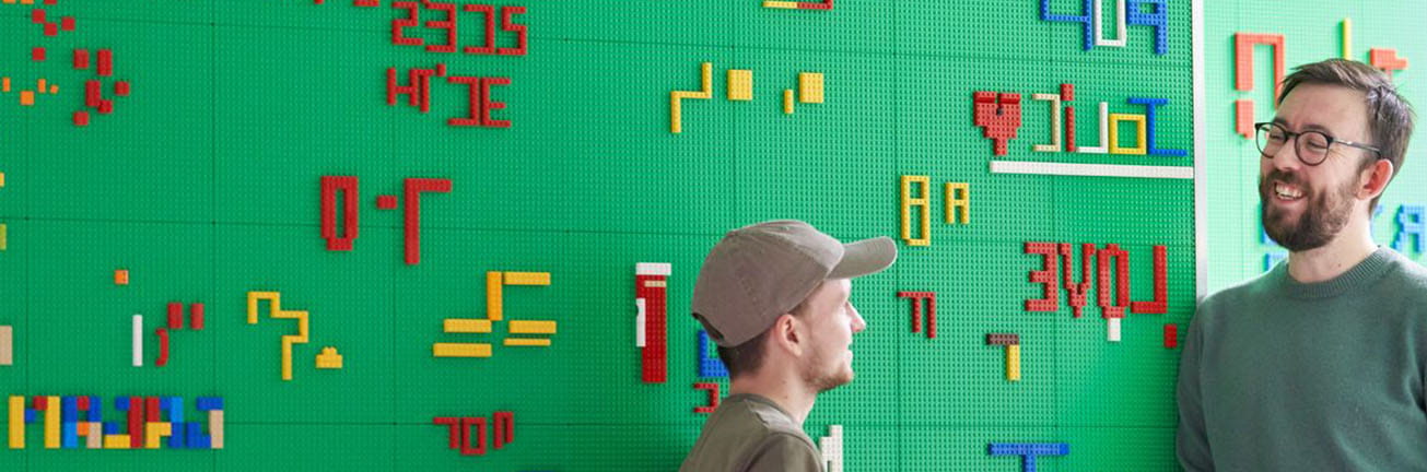 Two professionals collaborating in a diverse and inclusive workplace, representing the Adecco Group’s commitment to DE&I and workplace equity.