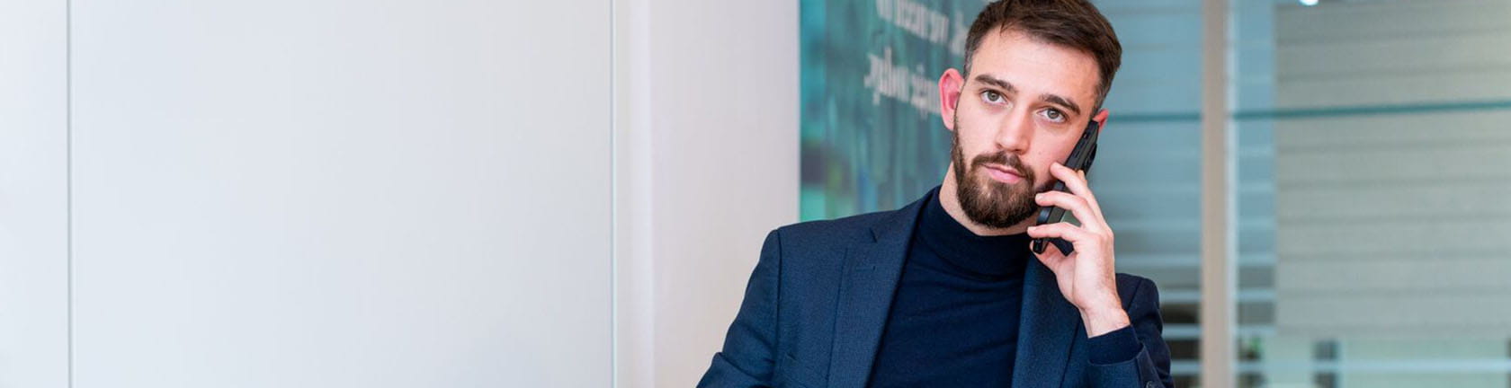 A business professional on the phone, symbolizing global client communication and corporate services.