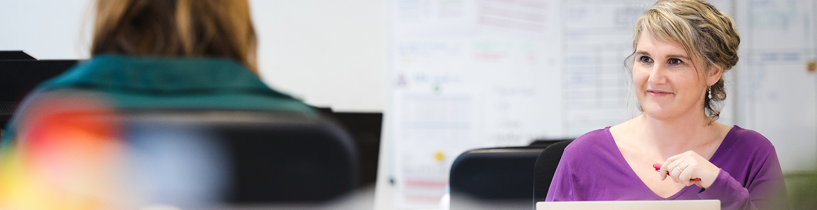 A professional recruiter engaging with a candidate in a modern office setting, discussing hiring and talent deployment strategies. A professional recruiter engaging with a candidate in a modern office setting, discussing hiring and talent deployment strategies.