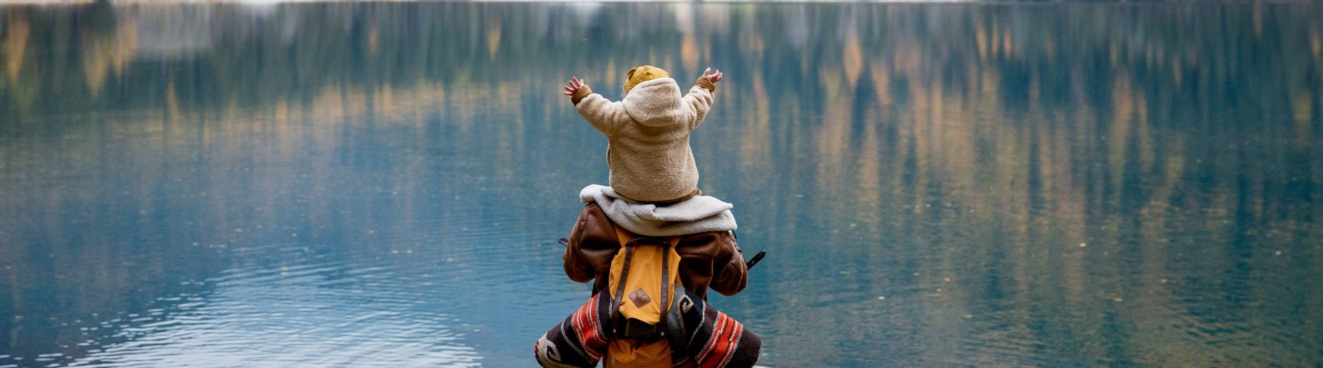 BANNER IMAGE - Parent and child hike through mountains