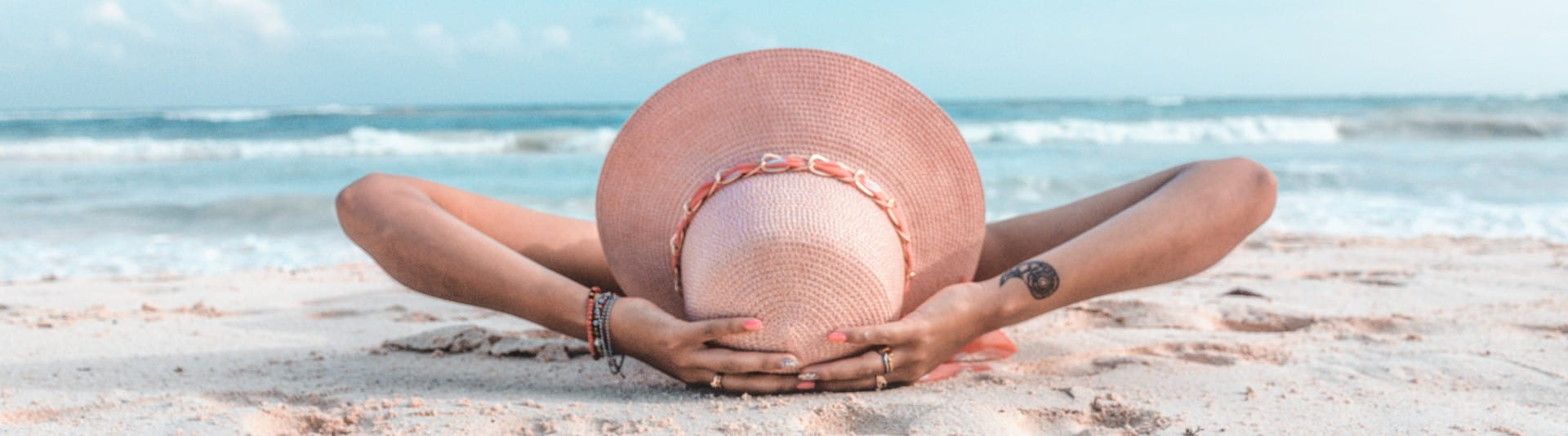 BANNER IMAGE - Woman relaxing on the beach